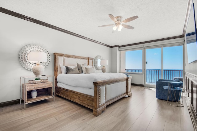 bedroom with a textured ceiling, light wood-style flooring, baseboards, access to outside, and crown molding