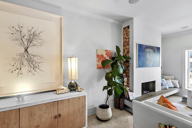 office space featuring a fireplace with raised hearth and crown molding