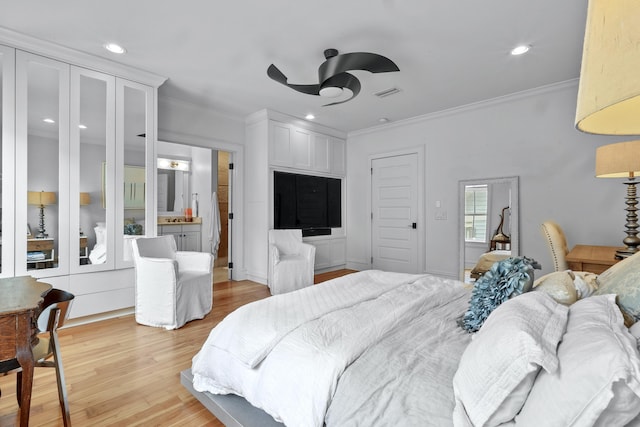 bedroom with recessed lighting, crown molding, and light wood-style flooring