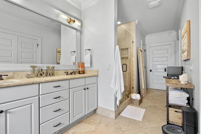 bathroom with a sink, double vanity, a shower stall, and crown molding