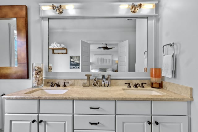 full bathroom featuring crown molding, a sink, and double vanity