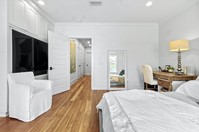 bedroom featuring recessed lighting, light wood-style flooring, visible vents, and ornamental molding