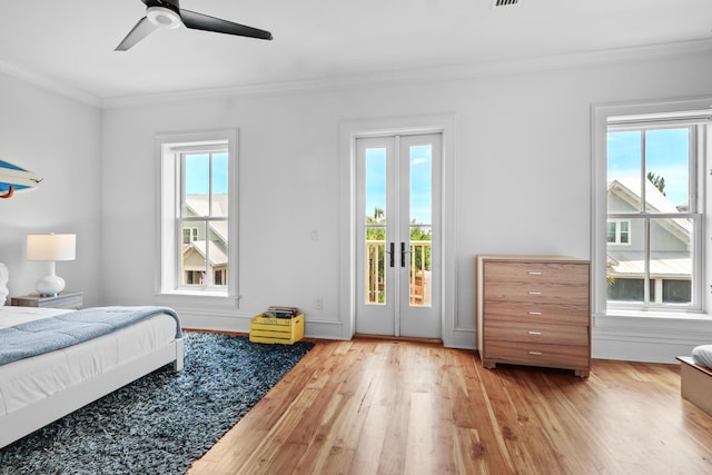 bedroom featuring access to exterior, french doors, a ceiling fan, ornamental molding, and wood finished floors