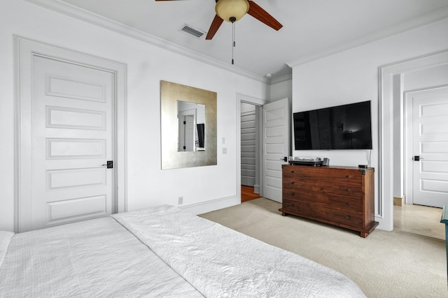 bedroom with carpet, crown molding, visible vents, ceiling fan, and baseboards