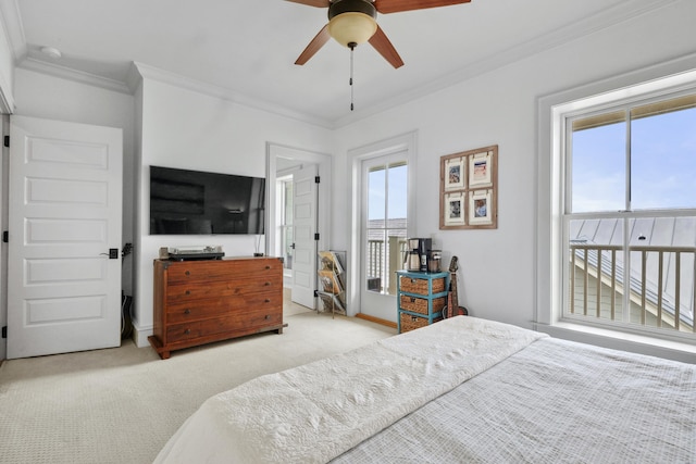 carpeted bedroom with access to outside, ornamental molding, and multiple windows