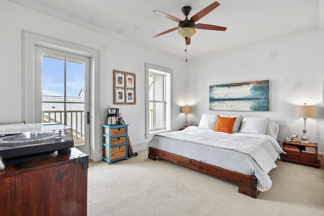 carpeted bedroom featuring access to exterior, ceiling fan, and crown molding