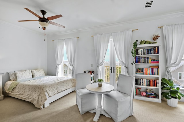 carpeted bedroom featuring access to outside, multiple windows, visible vents, and crown molding