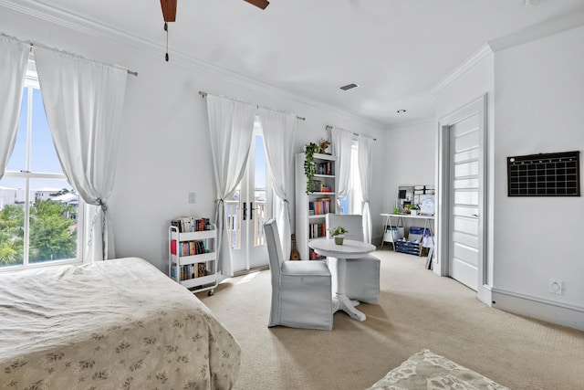 carpeted bedroom featuring ceiling fan, ornamental molding, visible vents, and baseboards