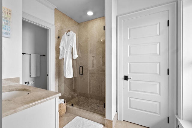 bathroom featuring a shower stall and vanity