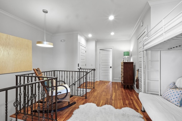 hall featuring recessed lighting, wood finished floors, an upstairs landing, baseboards, and ornamental molding