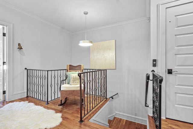 stairs featuring ornamental molding, wood finished floors, and baseboards