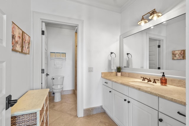 bathroom featuring crown molding, toilet, vanity, baseboards, and tile patterned floors