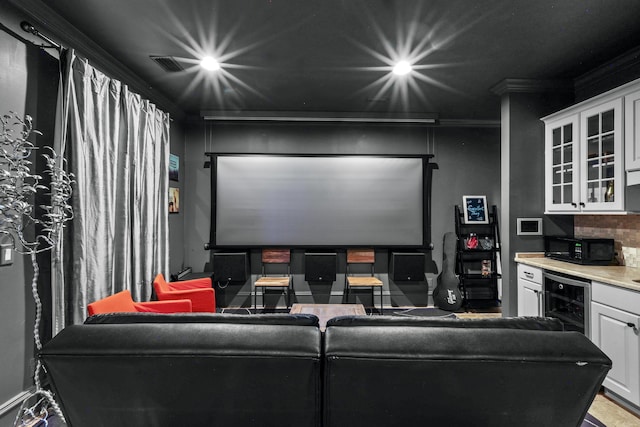 home theater featuring a bar, wine cooler, crown molding, and recessed lighting