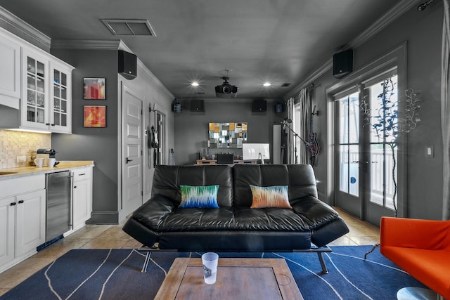 living area with a bar, wine cooler, visible vents, and ornamental molding