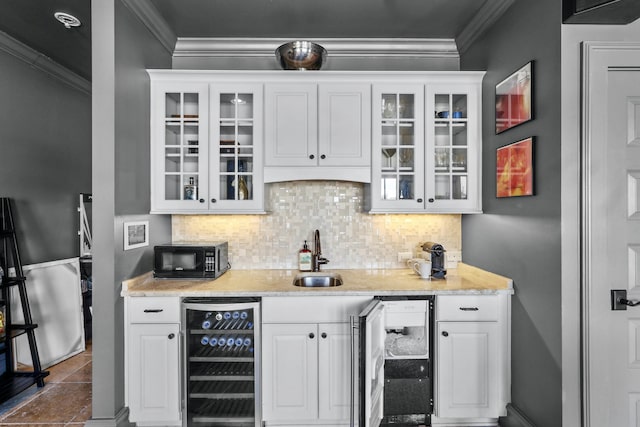 bar with black microwave, wine cooler, backsplash, and a sink