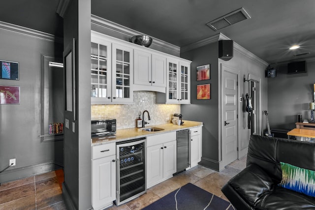 kitchen with beverage cooler, visible vents, crown molding, black microwave, and backsplash