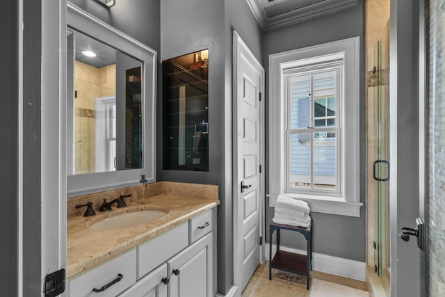 bathroom featuring a stall shower, baseboards, tile patterned floors, crown molding, and vanity