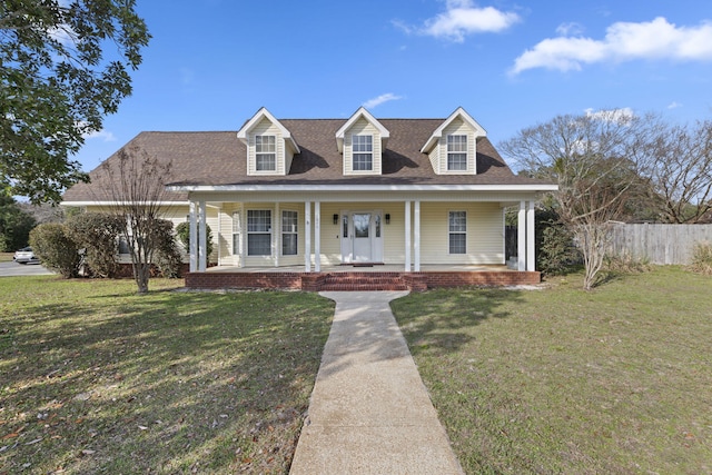 cape cod home featuring a front lawn and a porch