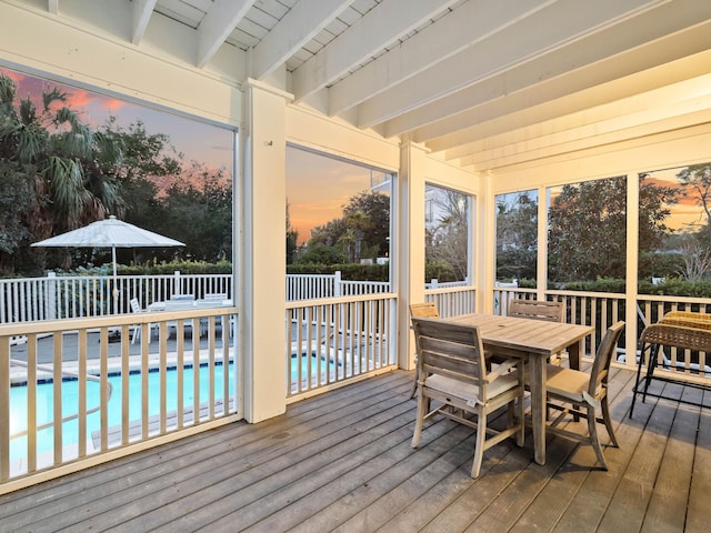 sunroom / solarium featuring beam ceiling