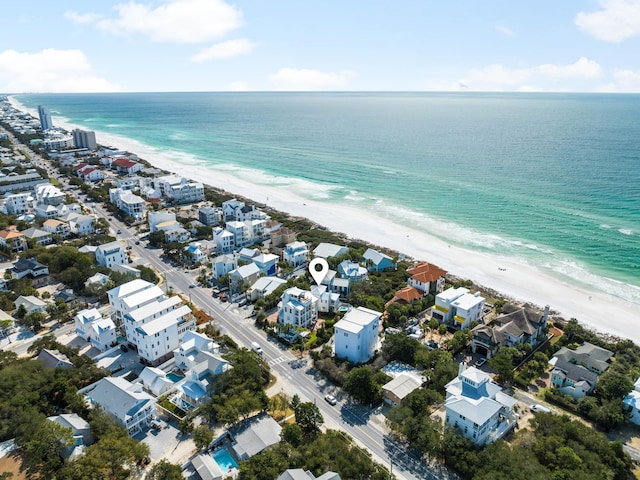 drone / aerial view featuring a view of the beach, a water view, and a residential view