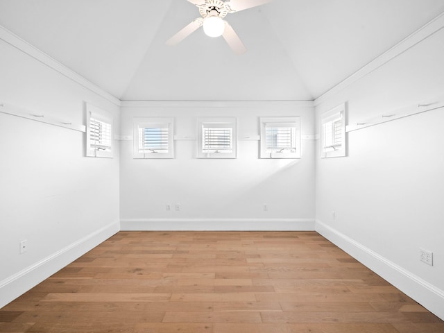 unfurnished room featuring light wood-style floors, a healthy amount of sunlight, vaulted ceiling, and a ceiling fan