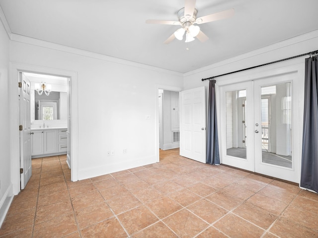 unfurnished bedroom featuring a sink, baseboards, access to outside, ornamental molding, and french doors