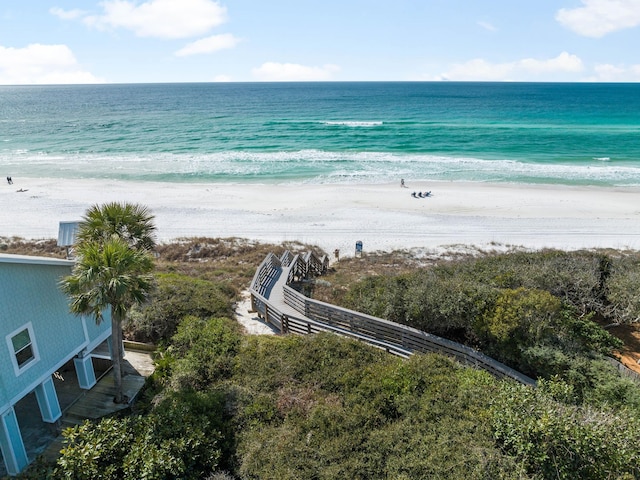 birds eye view of property with a view of the beach and a water view