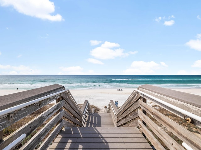 surrounding community with a beach view and a water view