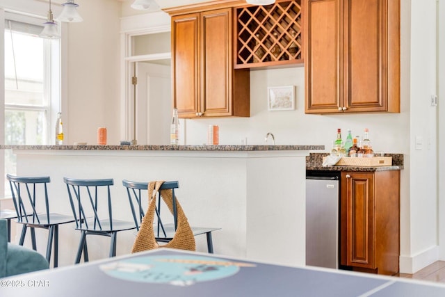 115 Cottage Ct, Panama City Beach, FL 32413 - kitchen featuring decorative light fixtures and stone counters