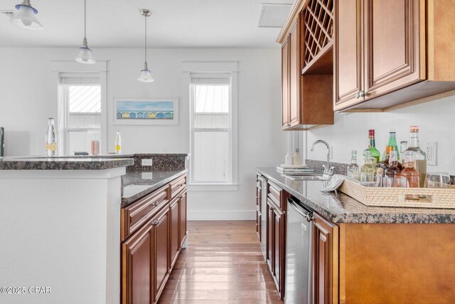 115 Cottage Ct, Panama City Beach, FL 32413 - kitchen featuring wine cooler, sink, hanging light fixtures, dark stone countertops, and hardwood / wood-style flooring