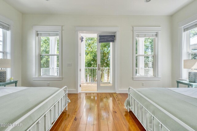 115 Cottage Ct, Panama City Beach, FL 32413 - bedroom featuring light hardwood / wood-style floors, multiple windows, and access to outside