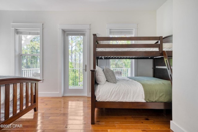115 Cottage Ct, Panama City Beach, FL 32413 - bedroom with access to exterior, hardwood / wood-style floors, and multiple windows