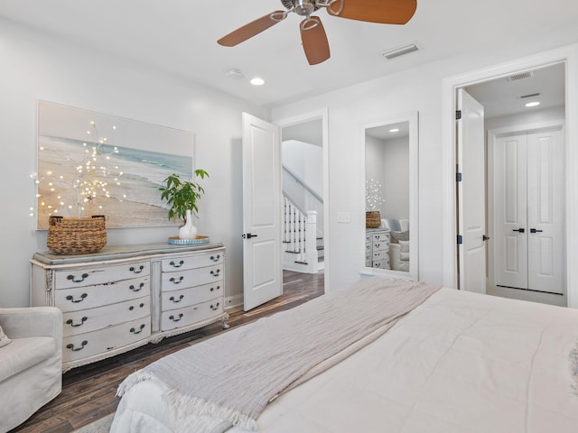 bedroom featuring dark wood-style floors, ceiling fan, and visible vents