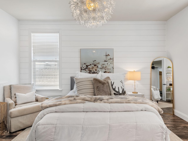 bedroom with dark wood-style floors and baseboards