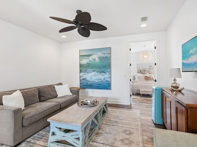 living room featuring recessed lighting, wood finished floors, a ceiling fan, baseboards, and visible vents