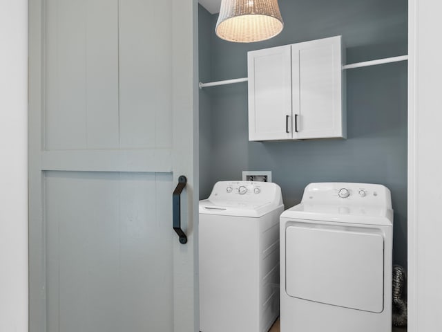 laundry area featuring cabinet space and washer and clothes dryer