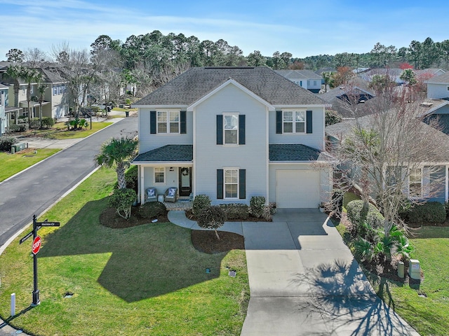 view of front of house featuring an attached garage, a residential view, a front lawn, and concrete driveway