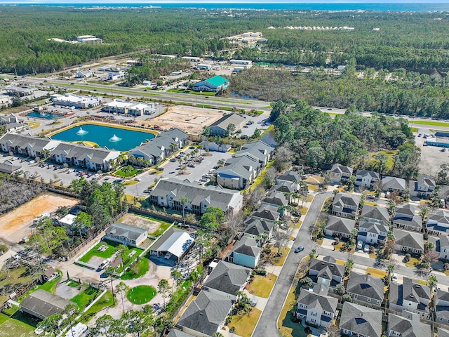 bird's eye view featuring a forest view and a residential view