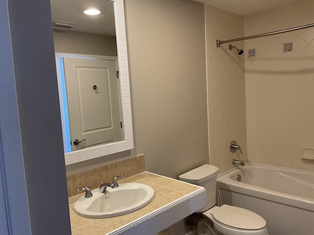 full bathroom with sink, toilet, and tiled shower / bath