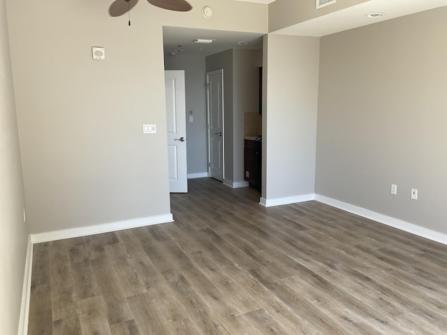 empty room featuring hardwood / wood-style flooring and ceiling fan