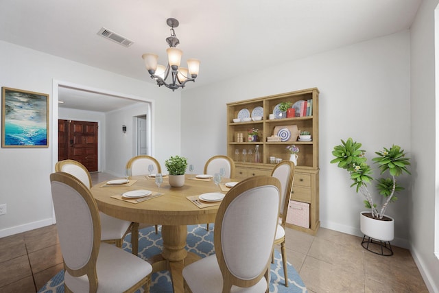 117 Hibiscus Ave, Gulf Breeze, FL 32561 - dining room with light tile patterned floors, baseboards, visible vents, and a notable chandelier