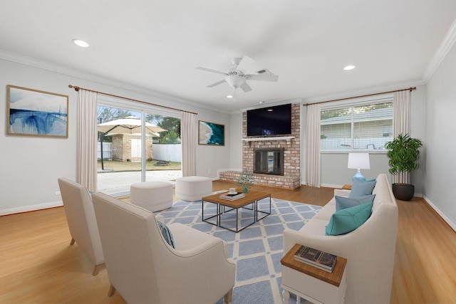 117 Hibiscus Ave, Gulf Breeze, FL 32561 - living area featuring plenty of natural light, a fireplace, crown molding, and light wood-style flooring