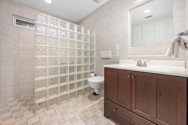 117 Hibiscus Ave, Gulf Breeze, FL 32561 - full bath with a walk in shower, toilet, recessed lighting, vanity, and tile walls