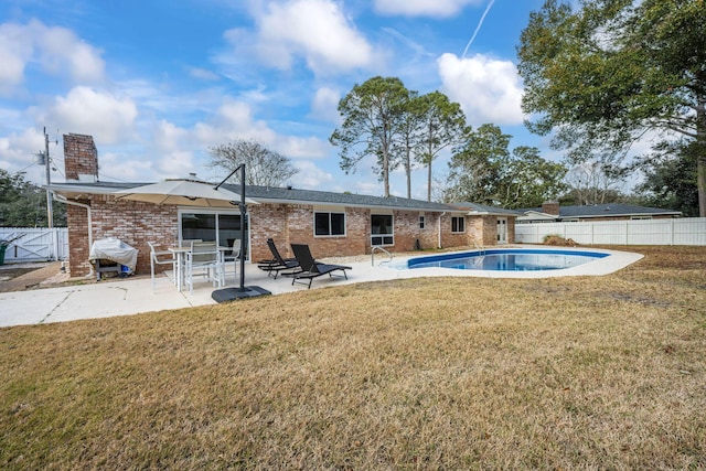 117 Hibiscus Ave, Gulf Breeze, FL 32561 - rear view of property with brick siding, a patio area, fence, and a fenced in pool