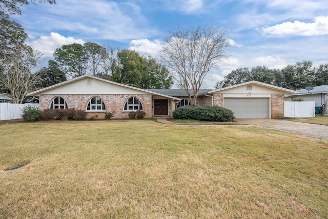 ranch-style home featuring driveway, an attached garage, fence, a front lawn, and brick siding