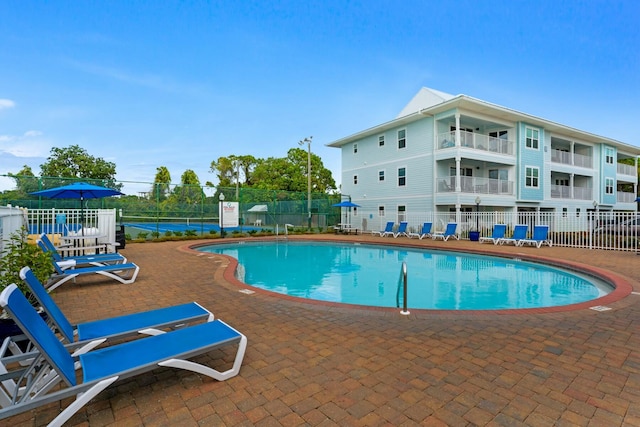 pool featuring a patio area and fence