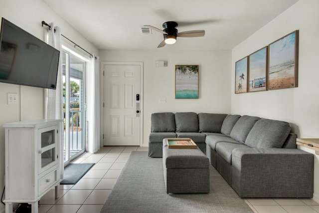 living room with ceiling fan, light tile patterned flooring, and visible vents