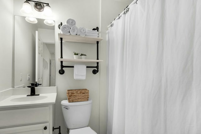 bathroom with toilet and vanity