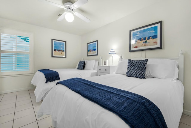 bedroom with light tile patterned floors, visible vents, baseboards, and a ceiling fan