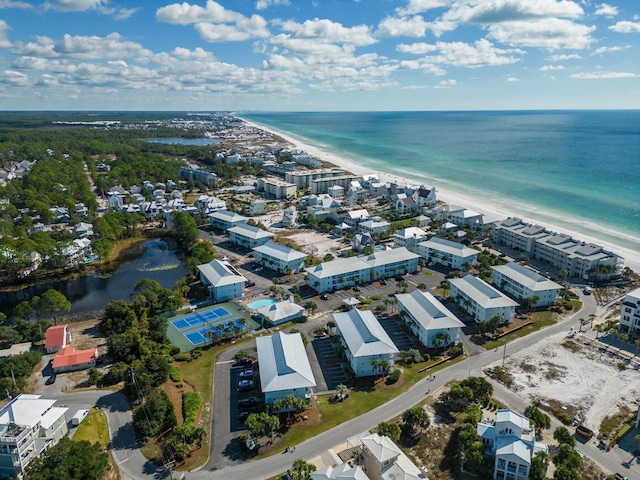 drone / aerial view with a water view and a beach view